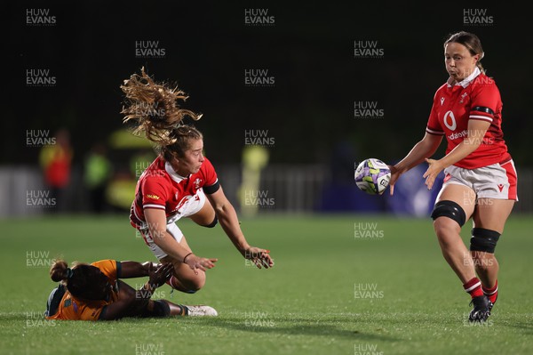 031123 - Wales Women v Australia Women, WXV1 - Lisa Neumann of Wales passes to Alisha Butchers of Wales as she is tackled by Ivania Wong of Australia
