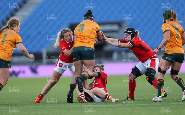 031123 - Wales Women v Australia Women, WXV1 - Hannah Bluck, Keira Bevan and Bethan Lewis of Wales combine to tackle Eva Karpani of Australia