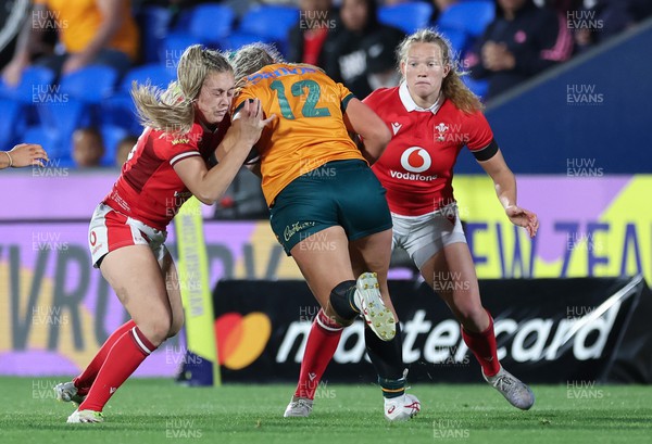 031123 - Wales Women v Australia Women, WXV1 - Hannah Jones of Wales and Carys Cox of Wales combine to tackle Arabella McKenzie of Australia
