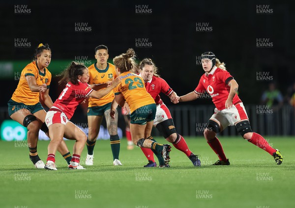 031123 - Wales Women v Australia Women, WXV1 - Meg Davies, Abbey Constable of Wales and Bethan Lewis of Wales combine to tackle Lori Cramer of Australia