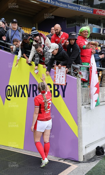 211023 - Wales Women v Canada Women, WXV1 - Hannah Jones of Wales signs autographs and poses for selfies at the end of the match