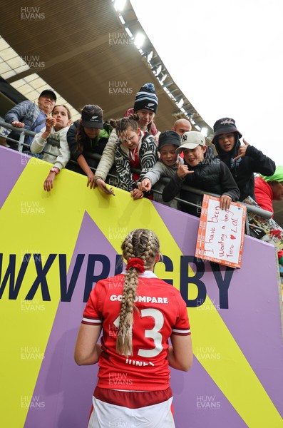 211023 - Wales Women v Canada Women, WXV1 - Hannah Jones of Wales signs autographs and poses for selfies at the end of the match