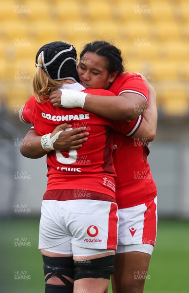 211023 - Wales Women v Canada Women, WXV1 - Bethan Lewis of Wales and Sisilia Tuipulotu of Wales embrace at the end of the match