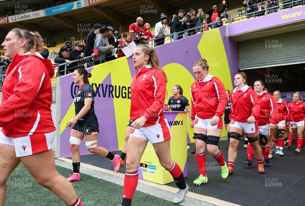 211023 - Wales Women v Canada Women, WXV1 - Gwenllian Pyrs of Wales, Lisa Neumann of Wales, Abbie Fleming of Wales and Kate Williams of Wales walk out at the start of the match