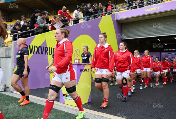 211023 - Wales Women v Canada Women, WXV1 - Abbie Fleming of Wales, Kate Williams of Walesand Abbey Constable of Wales walk out at the start of the match