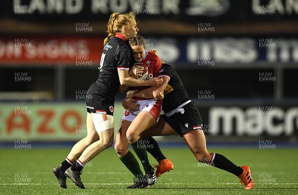211121 - Wales Women v Canada Women - Autumn Internationals - Caitlin Lewis of Wales is tackled by Sara Kaljuvee and Paige Farries of Canada