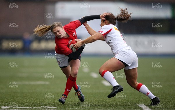 241118 - Wales Women v Canada Women - Friendly - Lauren Smyth of Wales is tackled by Sabrina Poulin of Canada