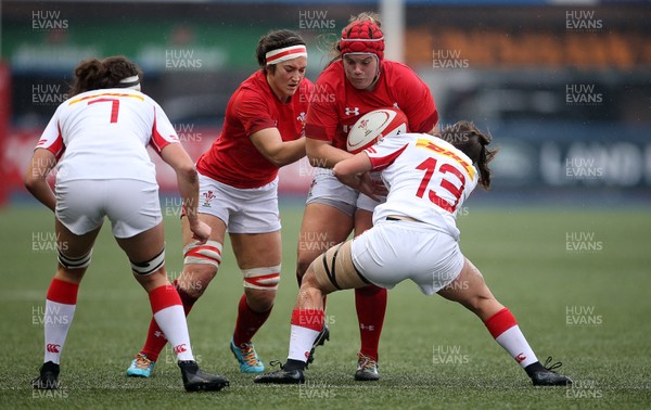 241118 - Wales Women v Canada Women - Friendly - Carys Phillips of Wales is tackled by Marie Thibault of Canada