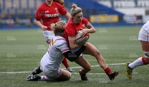 241118 - Wales Women v Canada Women - Friendly - Keira Bevan of Wales is tackled by Courtney Holtkamp of Canada