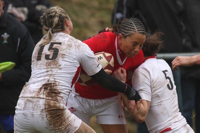 14.02.09 The Women's 6 Nations. Wales vs. England. Taffs Well RFC, Cardiff, Wales. 
 
Non Evans feels the impact of a double tackle by Victoria Massarrella(15) & Joanna McGilchrist. 
 

