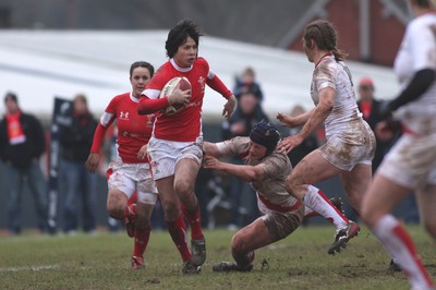 14.02.09 The Women's 6 Nations. Wales vs. England. Taffs Well RFC, Cardiff, Wales. 
 
Naomi Thomas leaves Sophie Hemming clutching at thin air as she looks to take on Karen Jones. 
 
