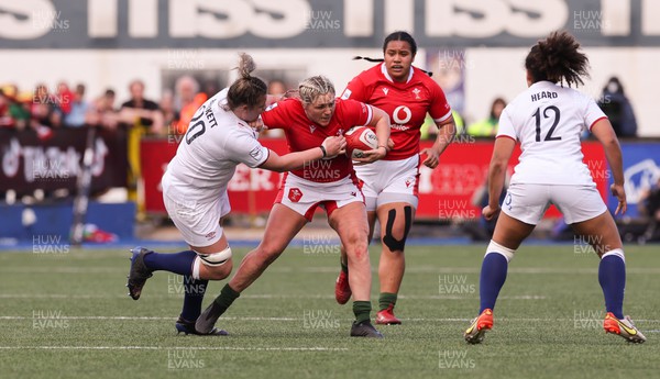 150423 - Wales v England, TicTok Women’s 6 Nations - Hannah Bluck of Wales holds off Sarah Beckett of England