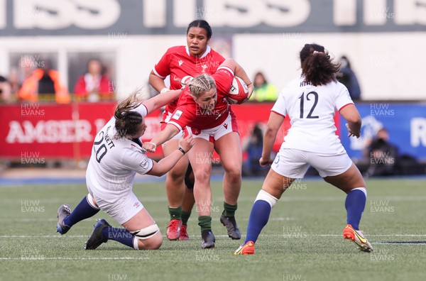 150423 - Wales v England, TicTok Women’s 6 Nations - Hannah Bluck of Wales holds off Sarah Beckett of England