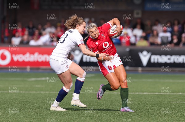 150423 - Wales v England, TicTok Women’s 6 Nations - Lowri Norkett of Wales is tackled by Ellie Kildunne of England