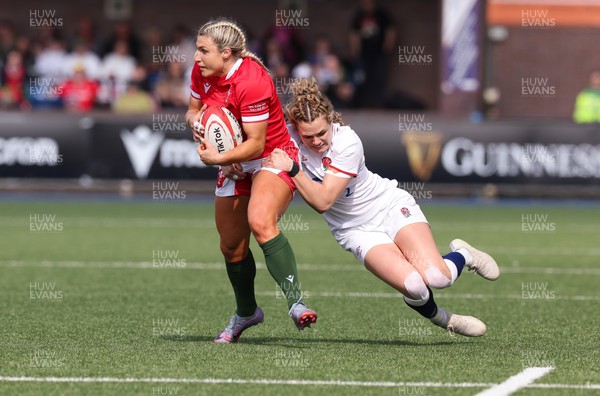 150423 - Wales v England, TicTok Women’s 6 Nations - Lowri Norkett of Wales is tackled by Ellie Kildunne of England