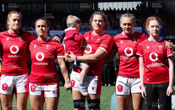 150423 - Wales v England, TicTok Women’s 6 Nations - Left to right, Lisa Neumann of Wales, Ffion Lewis of Wales, Natalia John of Wales with Morgan, and Hannah Jones of Wales with match mascot line up for the anthems