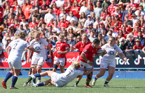 150423 - Wales v England, TicTok Women’s 6 Nations - Sisilia Tuipulotu of Wales is tackled by Marlie Packer of England