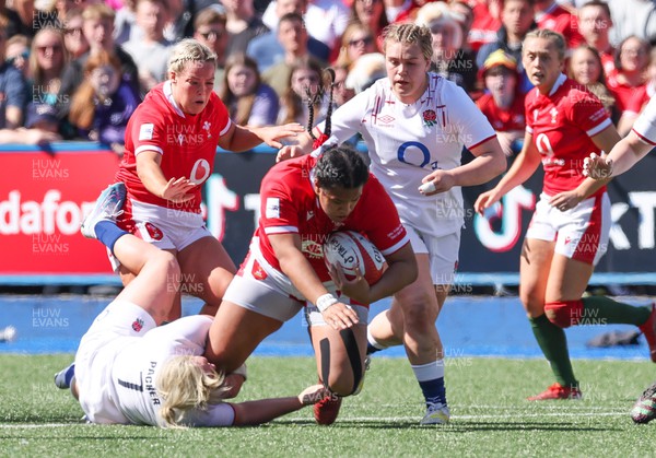 150423 - Wales v England, TicTok Women’s 6 Nations - Sisilia Tuipulotu of Wales is tackled by Marlie Packer of England