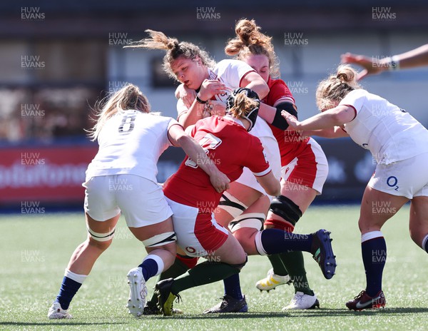 150423 - Wales v England, TicTok Women’s 6 Nations - Bethan Lewis of Wales and Abbie Fleming of Wales tackle Sarah Beckett of England