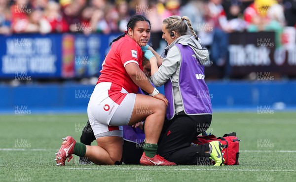 150423 - Wales v England, TicTok Women’s 6 Nations - Sisilia Tuipulotu of Wales is treated for a shoulder injury by medic Jo Perkins
