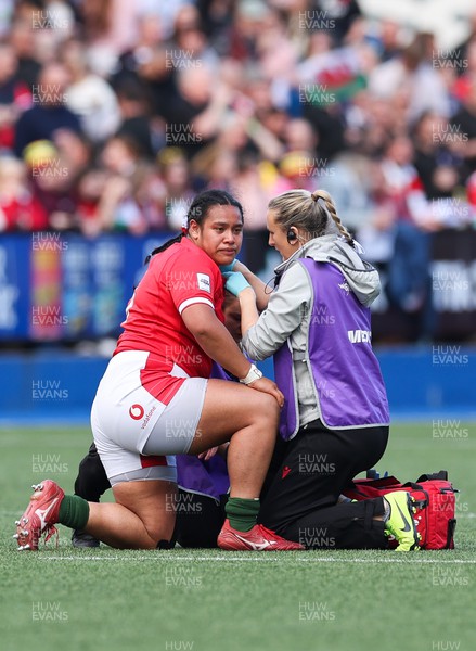 150423 - Wales v England, TicTok Women’s 6 Nations - Sisilia Tuipulotu of Wales is treated for a shoulder injury by medic Jo Perkins