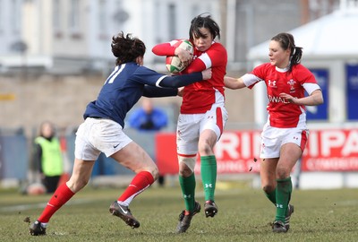 28.02.10 ... Wales Women v France Women, Womens Six Nations, Bridgend -  Wales' Clare Flowers is held by France's Caroline Ladagnous   