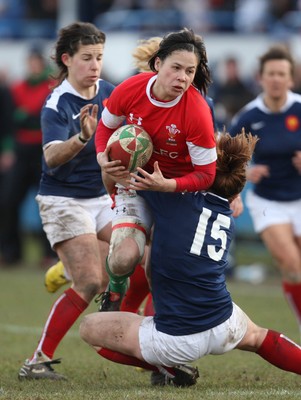 28.02.10 ... Wales Women v France Women, Womens Six Nations, Bridgend -  Wales' Naomi Thomas is tackled by France's Elodie Poublan  