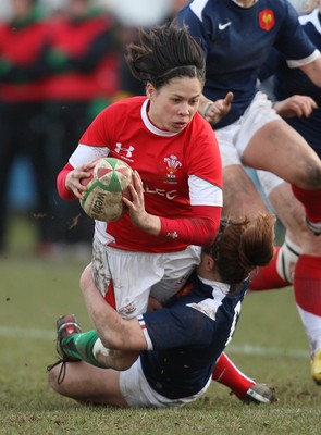 28.02.10 ... Wales Women v France Women, Womens Six Nations, Bridgend -  Wales' Naomi Thomas is tackled by France's Elodie Poublan  