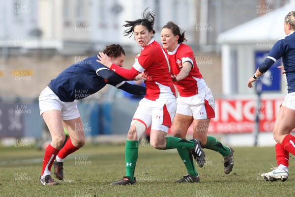 28.02.10 ... Wales Women v France Women, Womens Six Nations, Bridgend -  Wales' Naomi Thomas is held by France's Caroline Ladagnous   