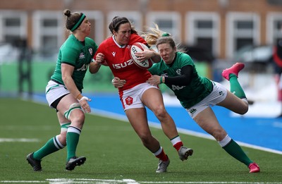 100421 - Wales Women v Ireland Women - Women's 2021 Six Nations Pool B - Courtney Keight of Wales is tackled by Lauren Delany and Ciara Griffin of Ireland