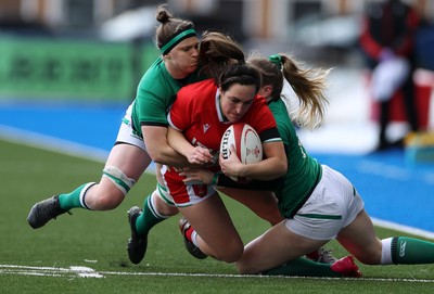 100421 - Wales Women v Ireland Women - Women's 2021 Six Nations Pool B - Courtney Keight of Wales is tackled by Lauren Delany and Ciara Griffin of Ireland