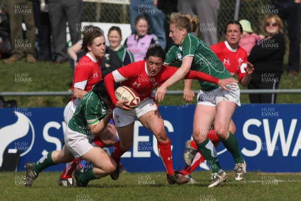 21.03.09 Wales vs. Ireland. Women's 6 Nations. Wales captain Mel Berry is tackled by Yvonne Nolan(L) & Jeannette Feighery.  