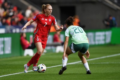 030625 - Wales Women v Italy Women - UEFA Women's Nations League - Ceri Holland of Wales Women is challenged by Angelica Soffia of Italy Women