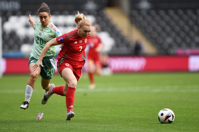 030625 - Wales Women v Italy Women - UEFA Women's Nations League - Ceri Holland of Wales Women is tackled by Angelica Soffia of Italy Women