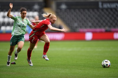 030625 - Wales Women v Italy Women - UEFA Women's Nations League - Ceri Holland of Wales Women is tackled by Angelica Soffia of Italy Women