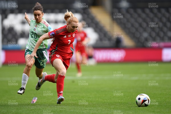 030625 - Wales Women v Italy Women - UEFA Women's Nations League - Ceri Holland of Wales Women is tackled by Angelica Soffia of Italy Women