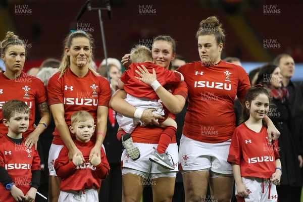 110318 - Wales Women v Italy Women - Natwest 6 Nations Championship - Jade Knight of Wales (centre) holds her son during the anthem alongside Kerin Lake and Carys Philips