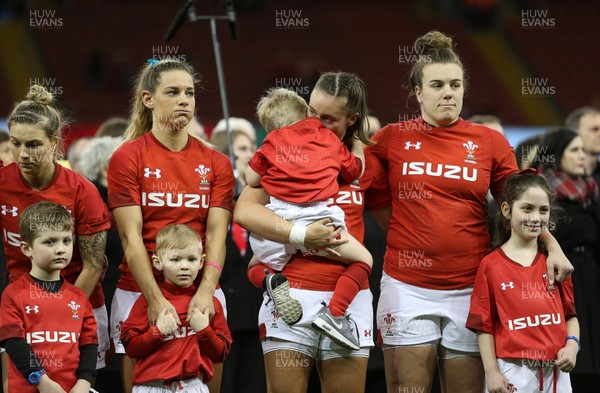 110318 - Wales Women v Italy Women - Natwest 6 Nations Championship - Jade Knight of Wales (centre) holds her son during the anthem alongside Kerin Lake and Carys Philips