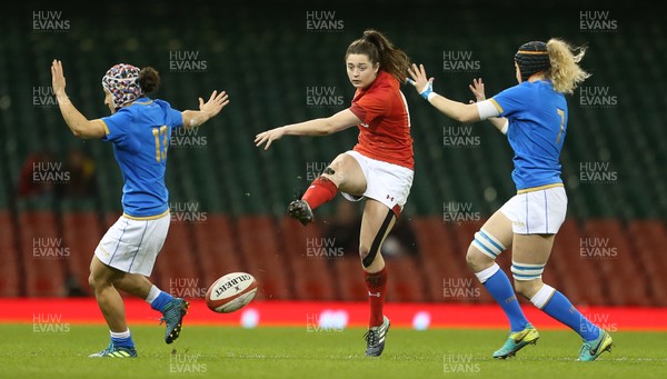 110318 - Wales Women v Italy Women - Natwest 6 Nations Championship - Robyn Wilkins of Wales kicks the ball through Michela Sillarri and Isabella Locatelli of Italy