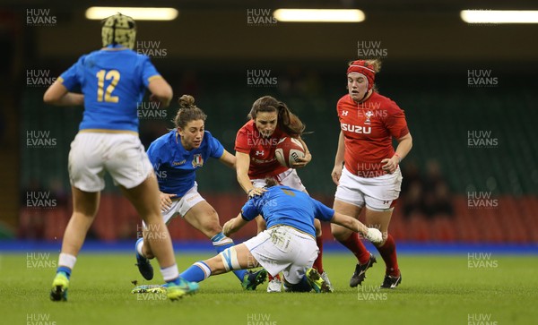 110318 - Wales Women v Italy Women - Natwest 6 Nations Championship - Jaz Joyce of Wales jumps over Elisa Giordano of Italy as she attempts to tackle her