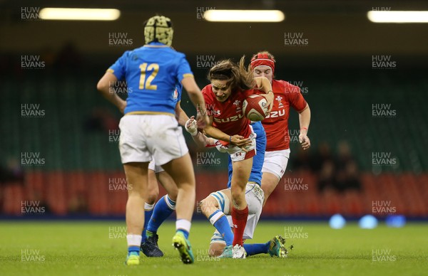 110318 - Wales Women v Italy Women - Natwest 6 Nations Championship - Jaz Joyce of Wales jumps over Elisa Giordano of Italy as she attempts to tackle her