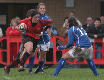 24.02.08 The Women's 6 Nations. Wales vs. Italy...  Mellissa Berry brushes off Valentina Schiavon's tackle as Veronica Sciavon(12) closes in.  