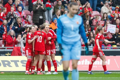 070326 - Wales v Montenegro - 2027 FIFA Women's World Cup Qualifying - Hannah Cain of Wales celebrates with team mates after scoring a goal