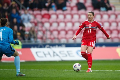 070326 - Wales v Montenegro - 2027 FIFA Women's World Cup Qualifying - Hannah Cain of Wales tries to chip Ajsa Kalac of Montenegro