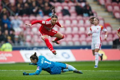070326 - Wales v Montenegro - 2027 FIFA Women's World Cup Qualifying - Hannah Cain of Wales tries to chip Ajsa Kalac of Montenegro