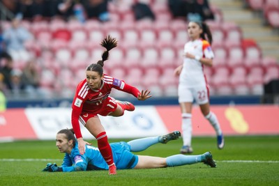 070326 - Wales v Montenegro - 2027 FIFA Women's World Cup Qualifying - Hannah Cain of Wales tries to chip Ajsa Kalac of Montenegro