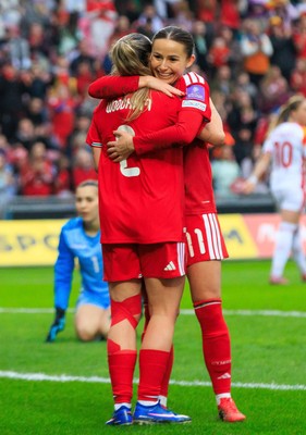 070326 - Wales v Montenegro - 2027 FIFA Women's World Cup Qualifying - Hannah Cain celebrates with Lily Woodham of Wales after scoring a goal