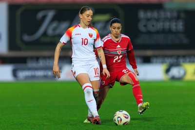 070326 - Wales v Montenegro - 2027 FIFA Women's World Cup Qualifying - Ffion Morgan of Wales and Jelena Karlicic of Montenegro