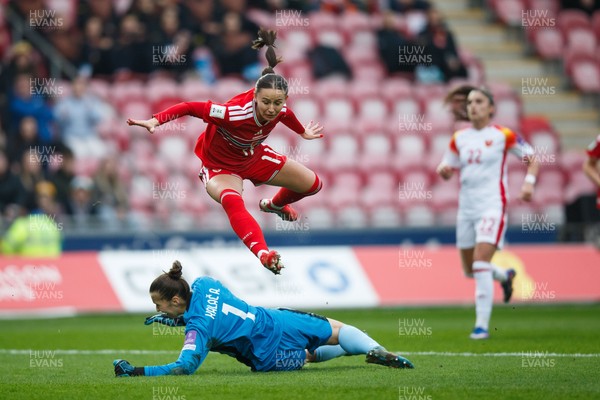 070326 - Wales v Montenegro - 2027 FIFA Women's World Cup Qualifying - Hannah Cain of Wales tries to chip Ajsa Kalac of Montenegro