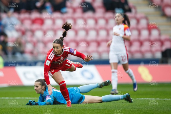 070326 - Wales v Montenegro - 2027 FIFA Women's World Cup Qualifying - Hannah Cain of Wales tries to chip Ajsa Kalac of Montenegro